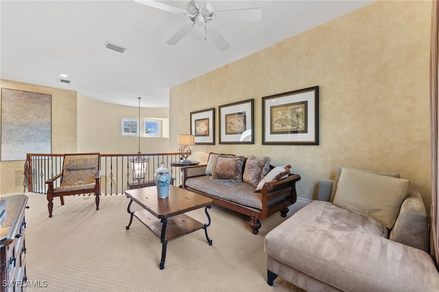 carpeted living room featuring ceiling fan