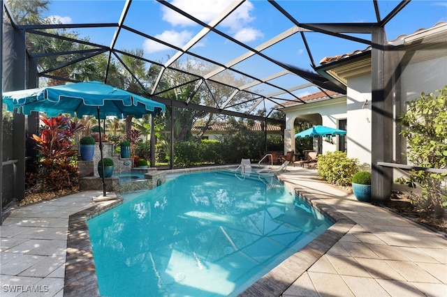 view of pool with glass enclosure, an in ground hot tub, and a patio