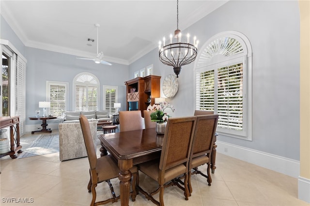 tiled dining room with ceiling fan with notable chandelier and crown molding