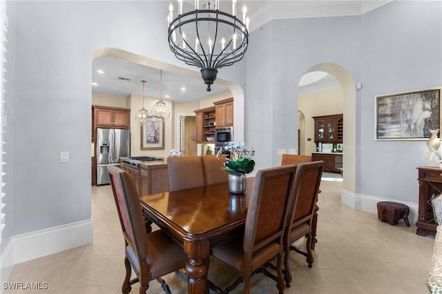 dining area featuring a notable chandelier, light tile patterned flooring, and crown molding