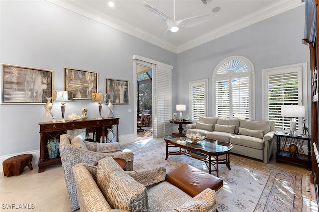 tiled living room with ceiling fan, a towering ceiling, and ornamental molding