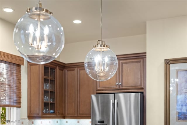 room details featuring pendant lighting and stainless steel fridge with ice dispenser