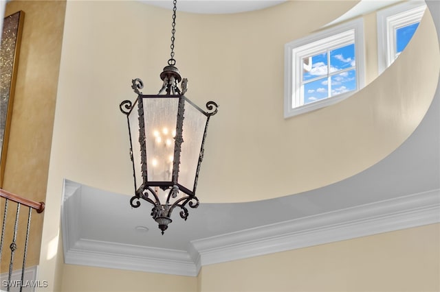 details featuring crown molding and an inviting chandelier