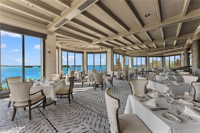 sunroom featuring beamed ceiling, a water view, and coffered ceiling