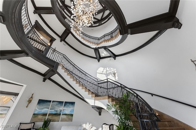 stairs featuring a chandelier