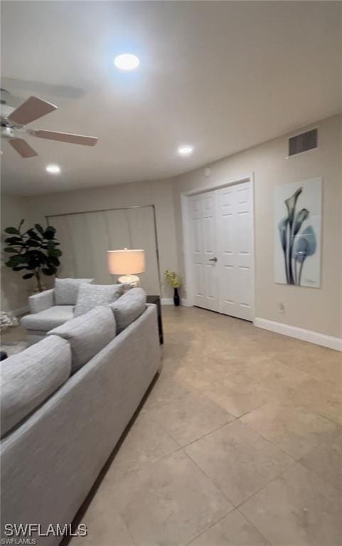 tiled living room featuring ceiling fan