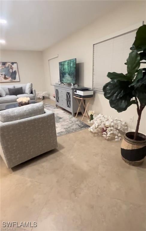 living room featuring concrete flooring