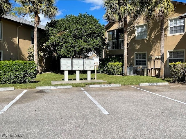 view of vehicle parking featuring a mail area