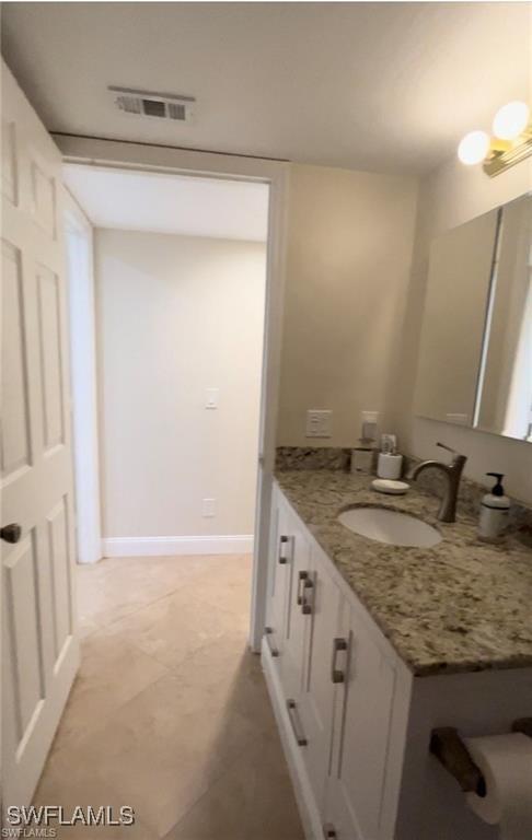 bathroom with vanity and tile patterned flooring