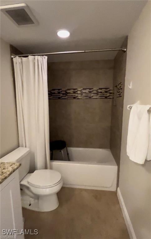 full bathroom with vanity, shower / tub combo, and toilet