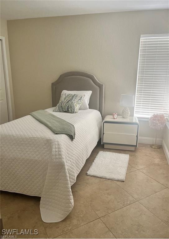 bedroom with light tile patterned flooring