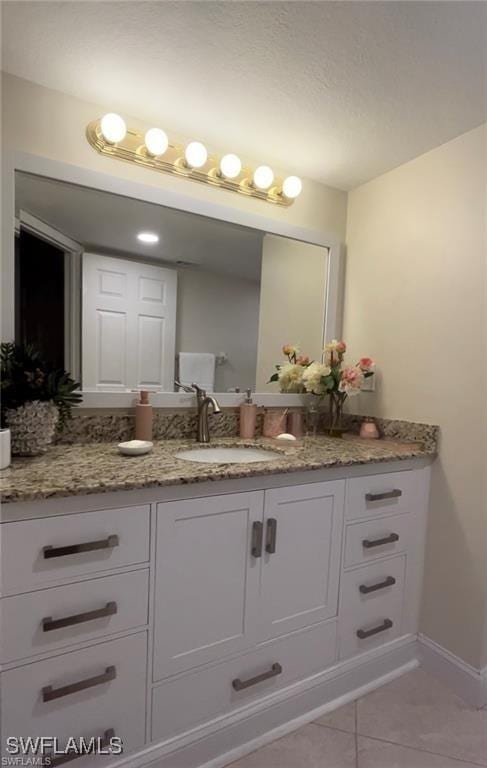 bathroom with tile patterned flooring and vanity