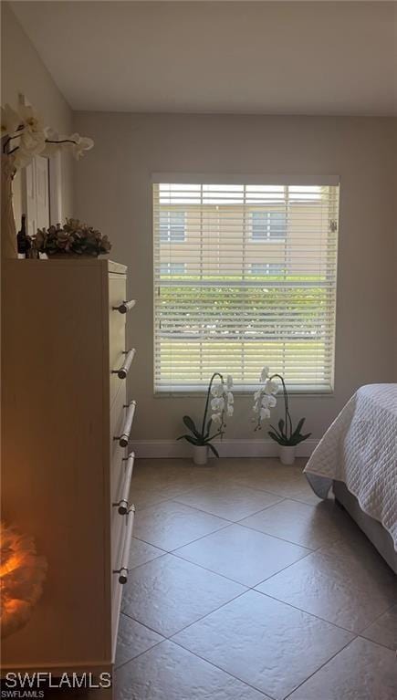 bedroom with light tile patterned floors