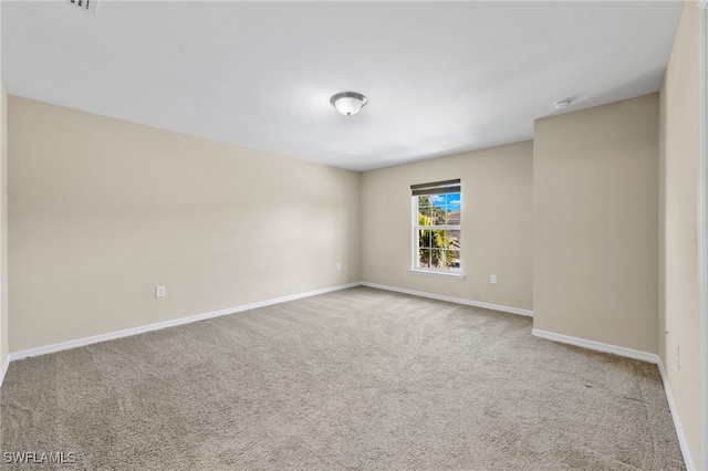 unfurnished room with light colored carpet