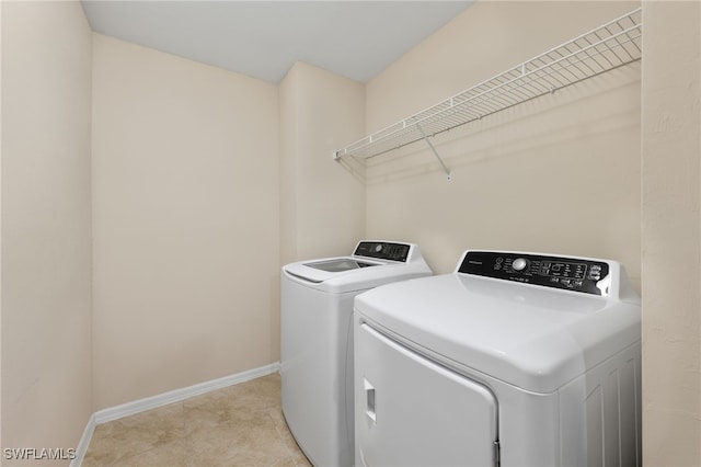 clothes washing area with separate washer and dryer