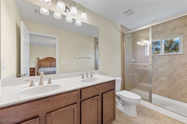 bathroom featuring tile patterned floors, vanity, toilet, and walk in shower