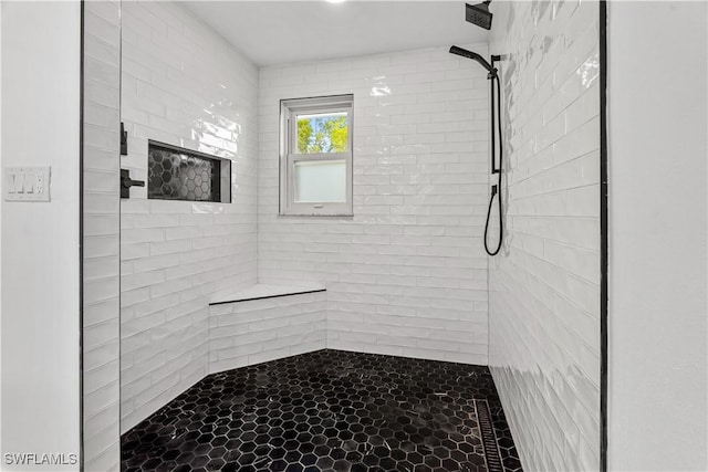 bathroom featuring a tile shower