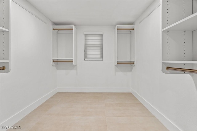 walk in closet with tile patterned floors