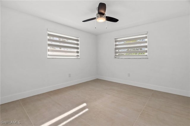 spare room with light tile patterned flooring and ceiling fan