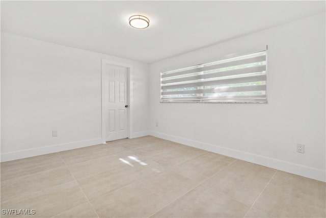 tiled spare room with plenty of natural light