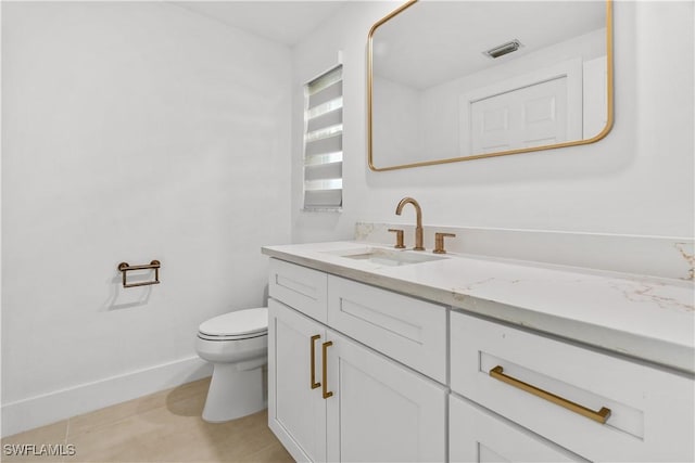 bathroom with tile patterned floors, vanity, and toilet