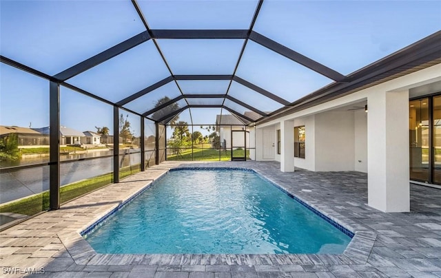 view of pool with a lanai, a patio, and a water view