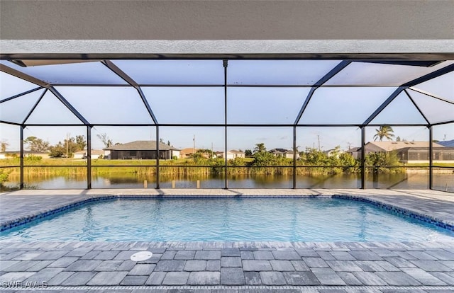 view of pool featuring a lanai and a water view