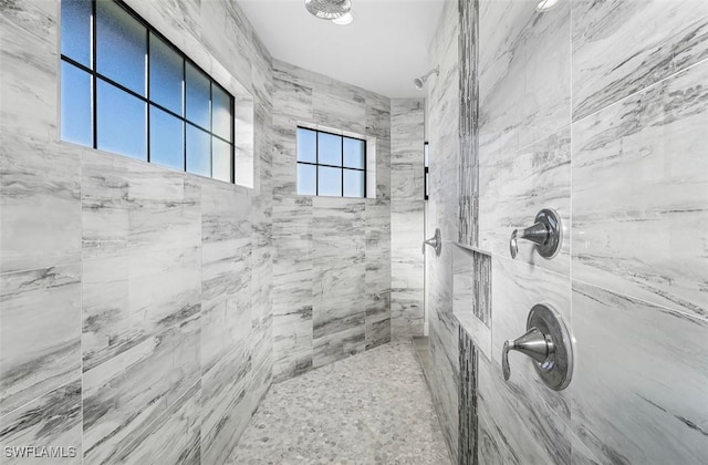 bathroom with tiled shower