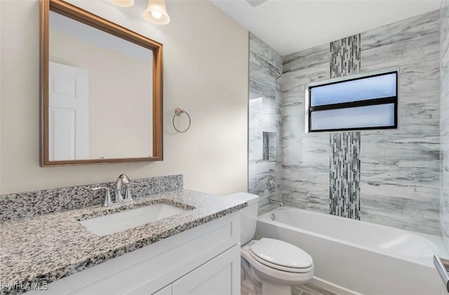 full bathroom with vanity, toilet, and tiled shower / bath