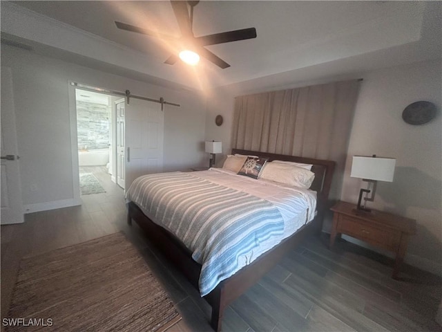 bedroom featuring dark hardwood / wood-style flooring, connected bathroom, and ceiling fan