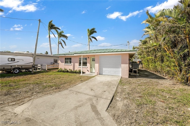 ranch-style house with a garage and a front lawn