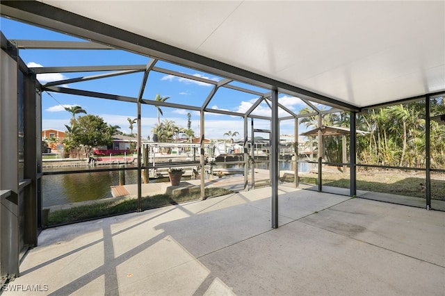 unfurnished sunroom with a healthy amount of sunlight and a water view