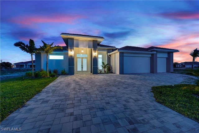 contemporary home featuring a garage and french doors