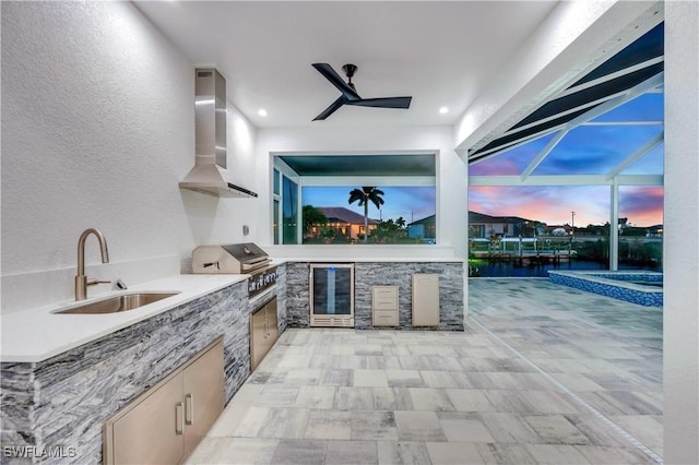 patio terrace at dusk featuring glass enclosure, an outdoor kitchen, sink, wine cooler, and a grill