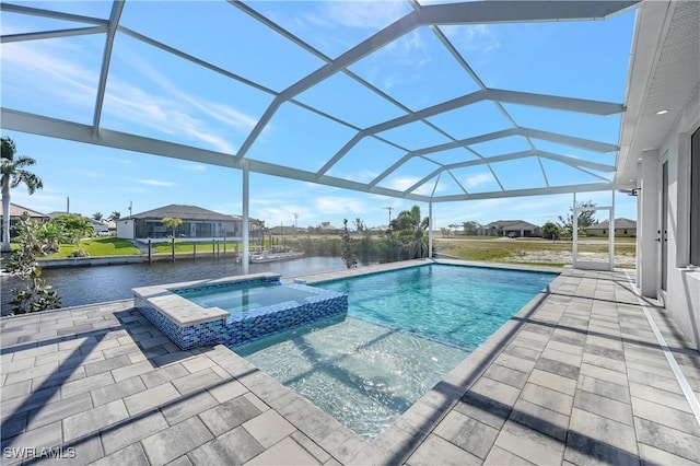 view of swimming pool with glass enclosure, an in ground hot tub, a patio area, and a water view