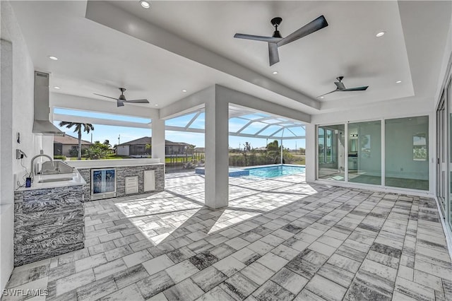 view of patio featuring a lanai, area for grilling, wine cooler, and a wet bar