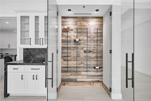 bathroom featuring washer / dryer and tasteful backsplash