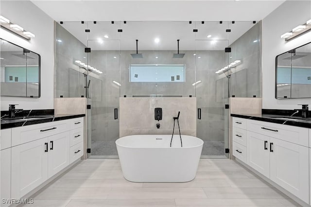 bathroom with vanity and shower with separate bathtub