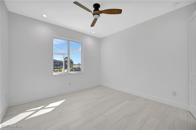 empty room featuring ceiling fan and light wood-type flooring