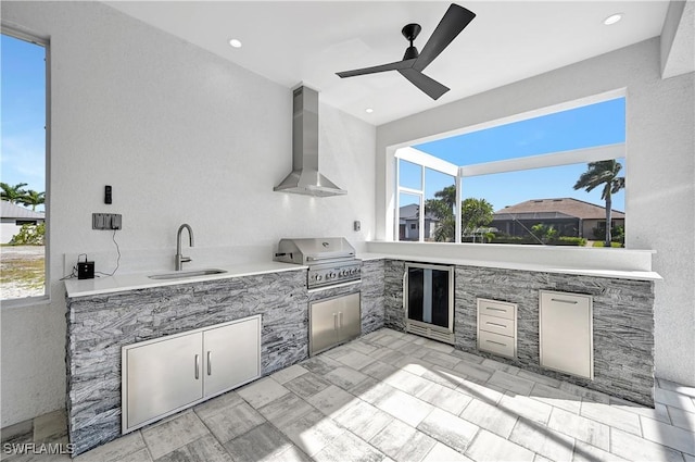 view of patio featuring a wet bar, area for grilling, ceiling fan, and a grill