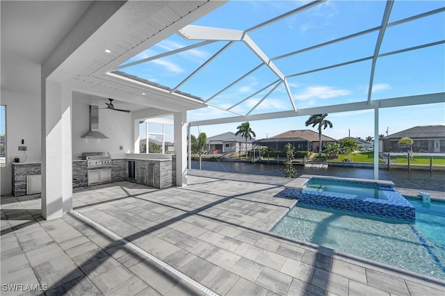 view of pool featuring an in ground hot tub, an outdoor kitchen, a water view, a patio, and a grill