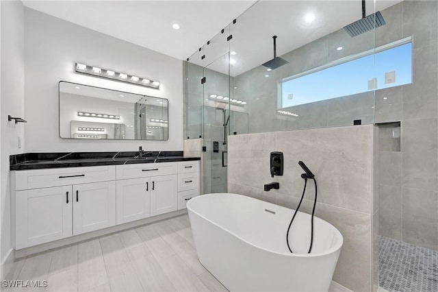 bathroom featuring separate shower and tub and vanity