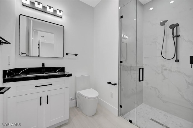 bathroom featuring vanity, toilet, and walk in shower