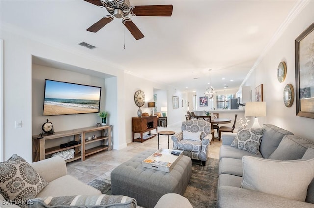 living room with ceiling fan and crown molding