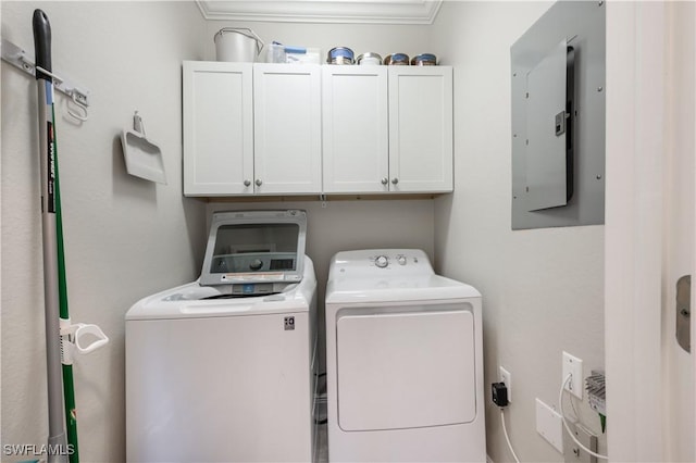 laundry area featuring cabinets, ornamental molding, electric panel, and washing machine and clothes dryer