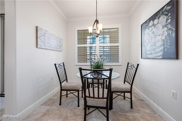 dining room with ornamental molding and a chandelier