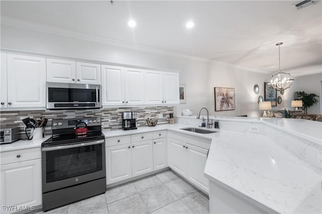 kitchen with sink, stainless steel appliances, an inviting chandelier, decorative backsplash, and white cabinets