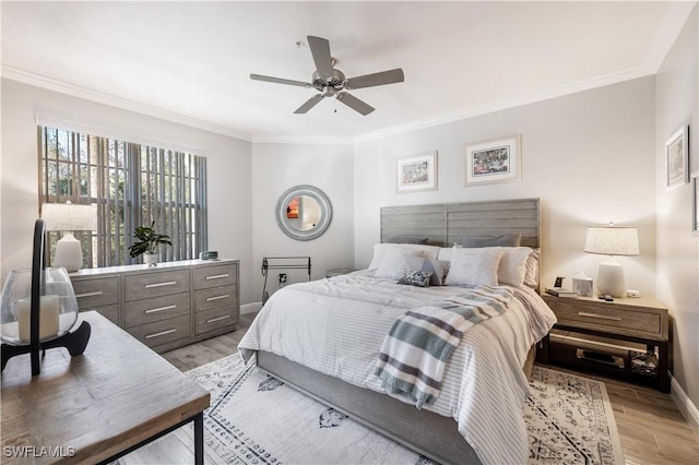 bedroom with ceiling fan, ornamental molding, and light hardwood / wood-style flooring