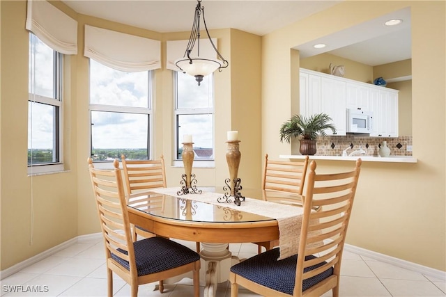 dining space with plenty of natural light and light tile patterned floors