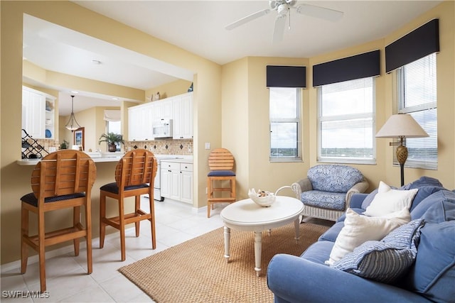 living room featuring ceiling fan and light tile patterned floors